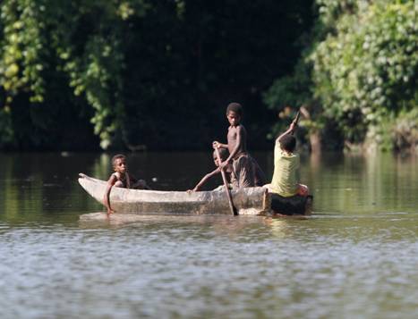 Local children in a canoe. Photo by Steve Bird.